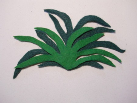 Felt carrot top pieces with smaller one over the larger, taller one.