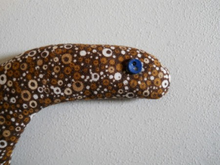 Button glued on as eye.