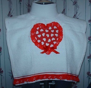 Tea towel cut for bib and decorated with Valentine's Day motif.