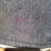 Red ink on gray hoodie.
