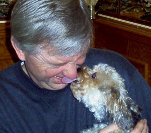 Dog giving man a kiss.