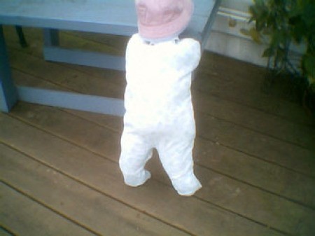 Standing baby on porch.