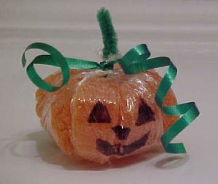 A cute candy pumpkin made from orange slices.