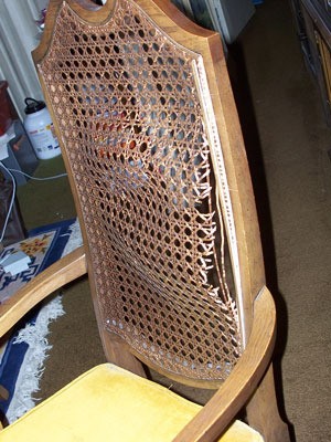 Broken cane back chair.