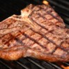 A T-bone steak on a grill.