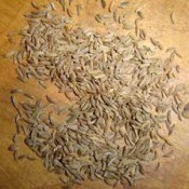 Caraway seeds on a wood table.