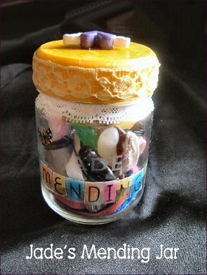 Decorated jar with mending supplies.