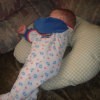 A baby sleeping on a handmade Boppy pillow.
