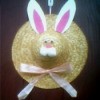 Straw hat with bunny ears, face, and a bow.