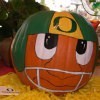 A pumpkin painted with an Oregon Ducks helmet.