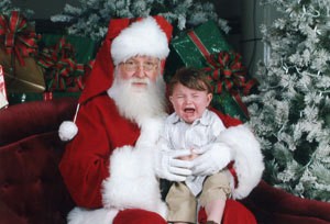 A picture of a child crying on Santa's lap.