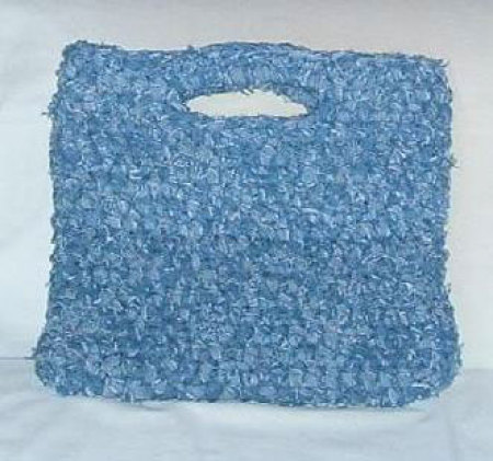 A crocheted rag bag made out of recycled denim jeans.