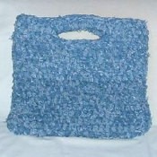 A crocheted rag bag made out of recycled denim jeans.