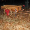 Wooden wagon with large red bow on wheel.