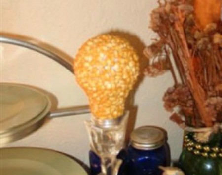 A recycled light bulb covered in popcorn.