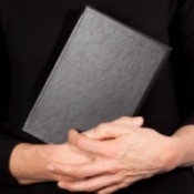 A pastor holding a bible.