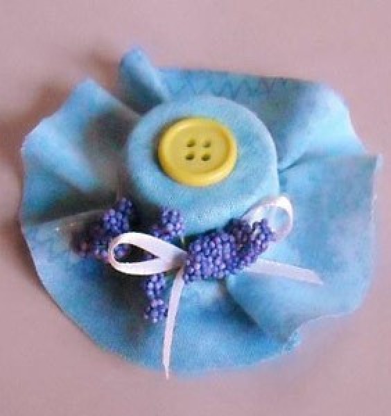 blue fabric covered cap in shape of bonnet