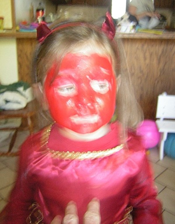 A girl dressed as a red devil.