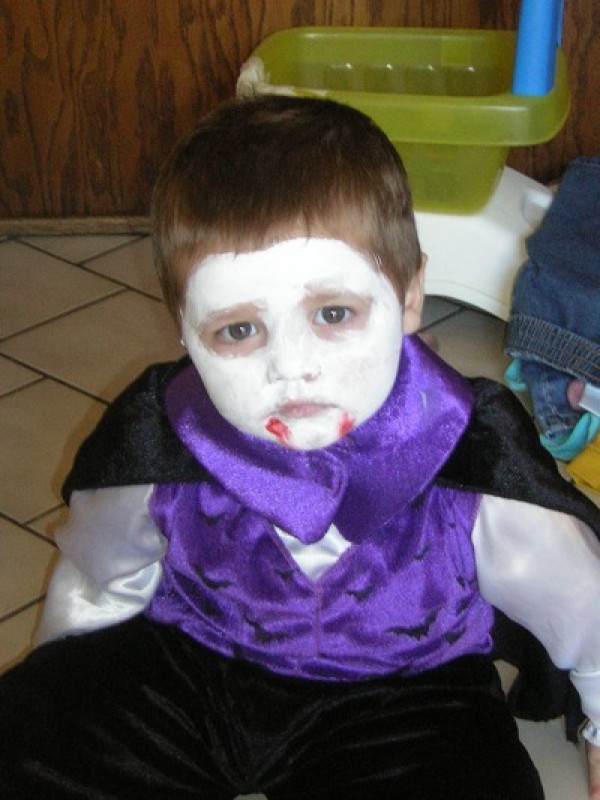 A boy dressed as a vampire.