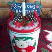 A decorative lighted welcome tin made from a recycled popcorn tin.