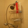 Using a thick rubber band to keep shower rack from sliding down the shower head.