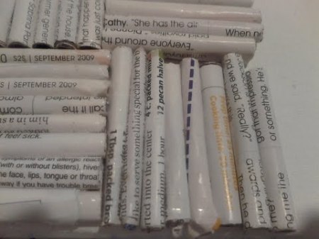 Rolls of white pages with black text.