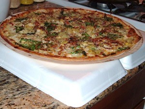 pizza sitting on bottom of Styrofoam container