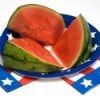 A watermelon on patriotic plates.