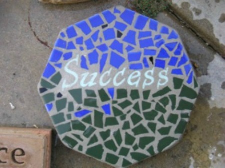 Mosaic Stepping Stone - using blue and green pieces and the word "Success" in center