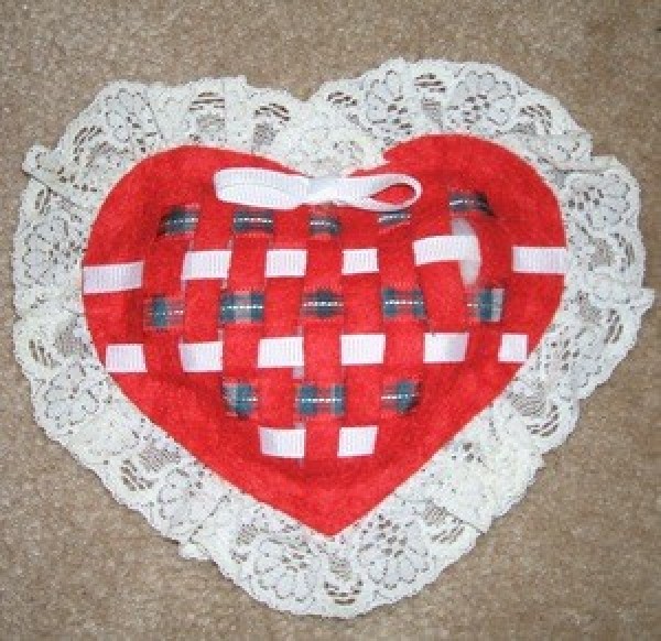 A woven felt sachet in the shape of a heart.