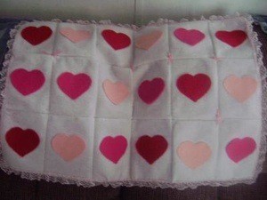 white blanket with red and pink hearts