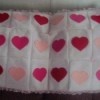 white blanket with red and pink hearts