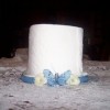 CD Spindle Toilet Paper Holder - TP on holder decorated with blue ribbon, faux flowers and a small butterfly