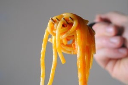 A fork of spaghetti being raised.