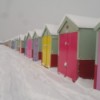 Multicolored huts in the snow.