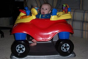 child in toy car