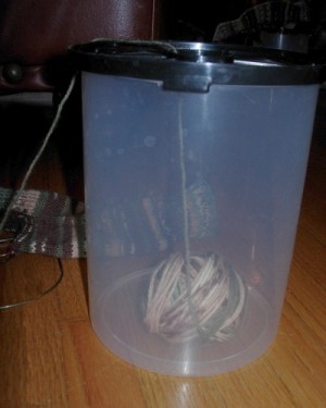 Side view of yarn ball in container.