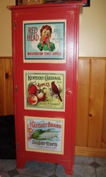 red painted cupboard with decoupaged calendar pages