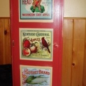 red painted cupboard with decoupaged calendar pages
