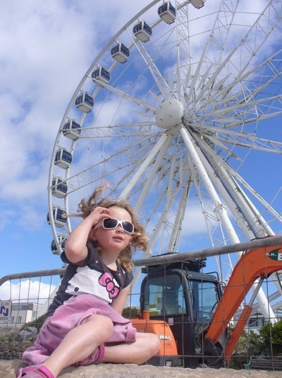 Girl near wheel.