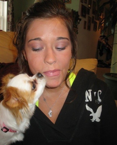 Dog licking a woman's face.