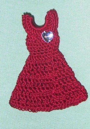 Red dress crocheted pin.