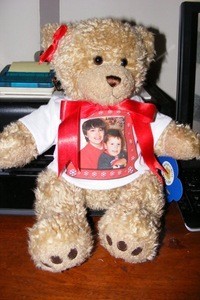 A build a bear stuffed animal with a photo T-shirt.