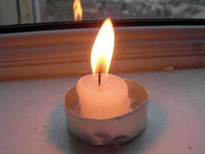 A candle stub in an old tea light holder.