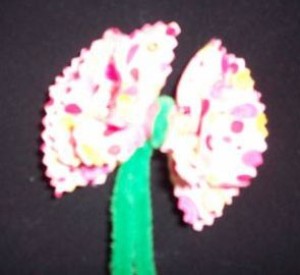 A flower made from fabric and chenille pipe cleaners.