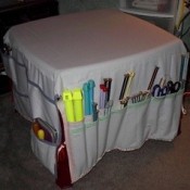 Fabric table cover with pockets for organizing craft supplies and tools.