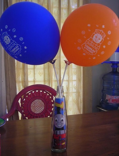 bottle picture of Thomas the Train inside and two balloons