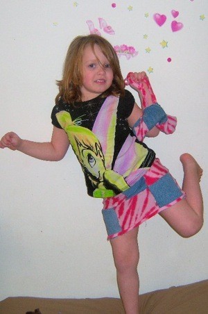 Young girl wearing a patchwork skirt.