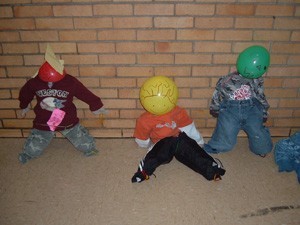Scarecrows made with toddler clothing and balloon heads.