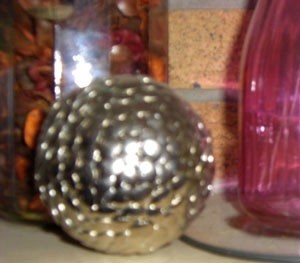 A decorative orb made form thumbtacks.